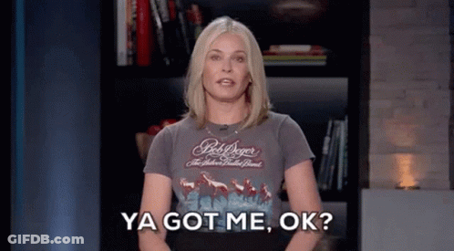 A Woman In A Bob Dylan Shirt Is Standing In Front Of A Bookshelf And Saying Ya Got Me , Ok . GIF