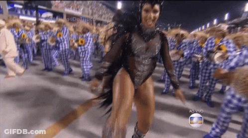 A Woman In A Bodysuit Is Dancing In Front Of A Crowd With The Words Ao Vivo On The Bottom GIF