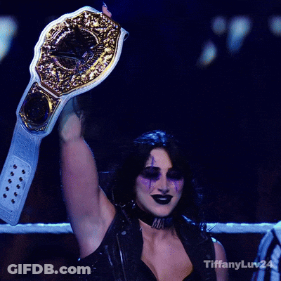 A Woman In A Boxing Ring Holding A Championship Belt With Tiffanyluv24 Written On The Bottom Right GIF