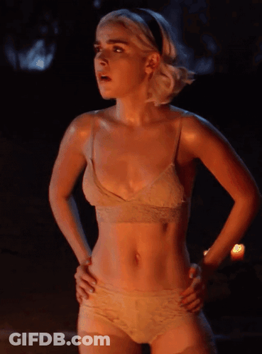 A Woman In A Bra And Panties Is Standing With Her Hands On Her Hips GIF