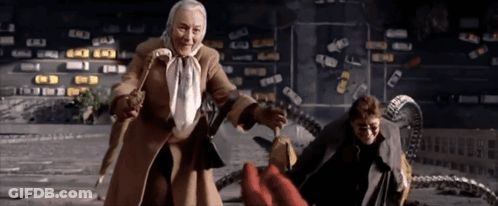 A Woman In A Brown Coat Is Standing Next To A Man GIF