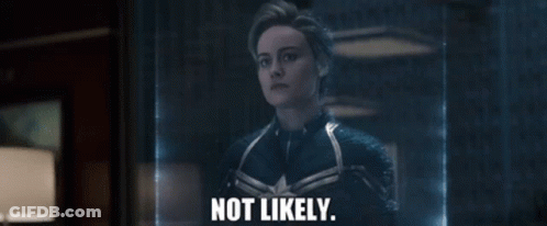 A Woman In A Captain Marvel Suit Is Standing In Front Of A Glass Wall And Says `` Not Likely '' . GIF