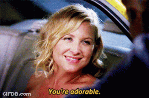 A Woman In A Car Is Smiling And Says You 'Re Adorable In Yellow Letters GIF