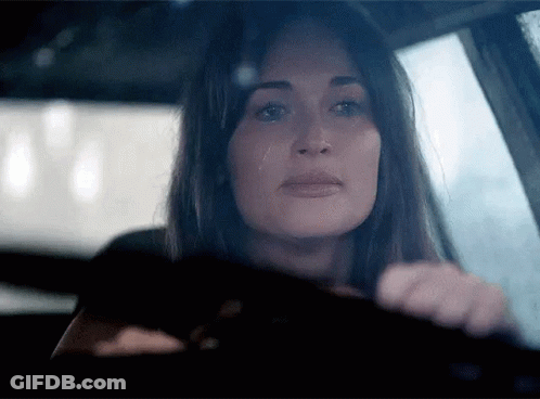 A Woman In A Car With A Tear Running Down Her Cheek GIF