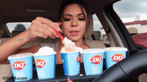 A Woman In A Car With A Tray Of Dq Cups GIF