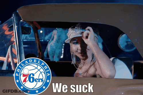 A Woman In A Car With The Philadelphia 76Ers Logo GIF