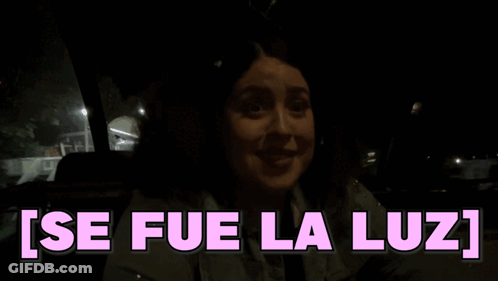 A Woman In A Car With The Words Se Fue La Luz Written In Pink GIF