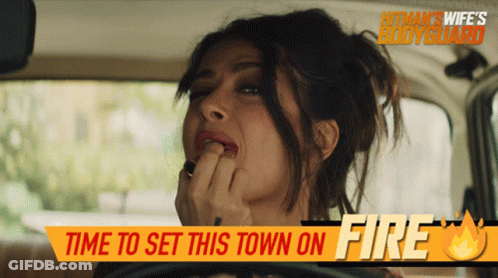 A Woman In A Car With The Words Time To Set This Town On Fire GIF