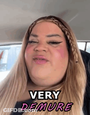 A Woman In A Car With The Words Very Demure Written On Her Face GIF