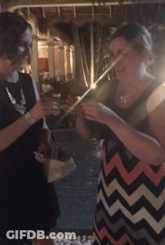 A Woman In A Chevron Dress Is Holding A Straw GIF