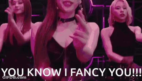 A Woman In A Choker Is Dancing With Two Other Women . GIF