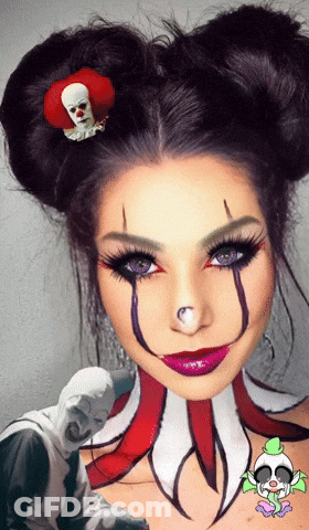 A Woman In A Clown Costume Has A Clown Pin On Her Hair GIF