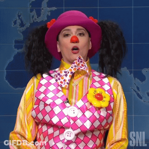 A Woman In A Clown Costume Is Making A Funny Face With Her Mouth Open . GIF