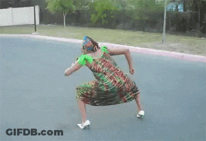 A Woman In A Colorful Dress Is Dancing On A Road GIF