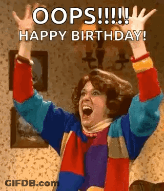 A Woman In A Colorful Sweater Is Raising Her Arms In The Air . GIF