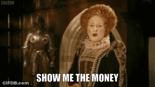 A Woman In A Costume Says Show Me The Money In Front Of A Statue GIF