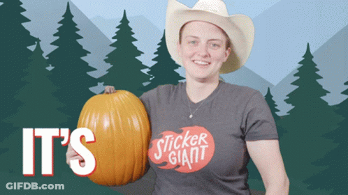 A Woman In A Cowboy Hat Is Holding A Pumpkin That Says It 'S Sticker Giant On It GIF