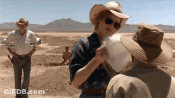 A Woman In A Cowboy Hat Is Talking To A Man In A Cowboy Hat . GIF