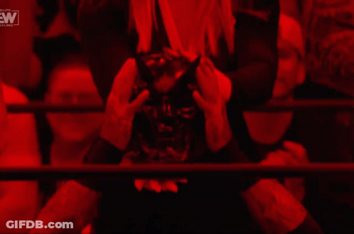 A Woman In A Cowboy Hat Stands In A Dark Room With A Ew Logo In The Corner GIF