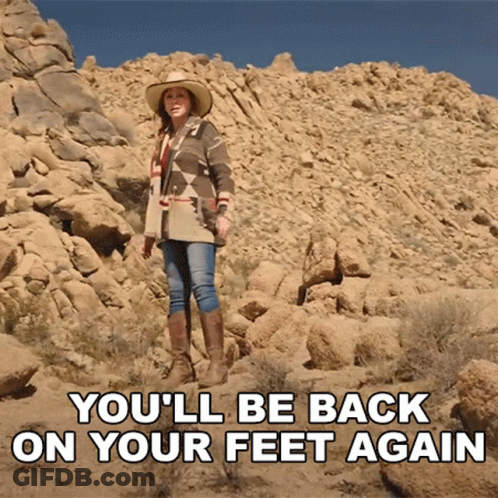 A Woman In A Cowboy Hat Stands On A Rocky Hillside With The Words " You 'Ll Be Back On Your Feet Again " GIF