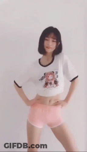 A Woman In A Crop Top And Pink Shorts Is Dancing . GIF