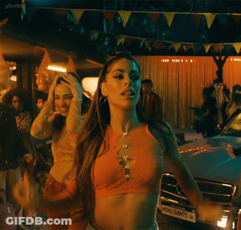 A Woman In A Crop Top Is Dancing In Front Of A Car With A License Plate That Says Ante On It GIF