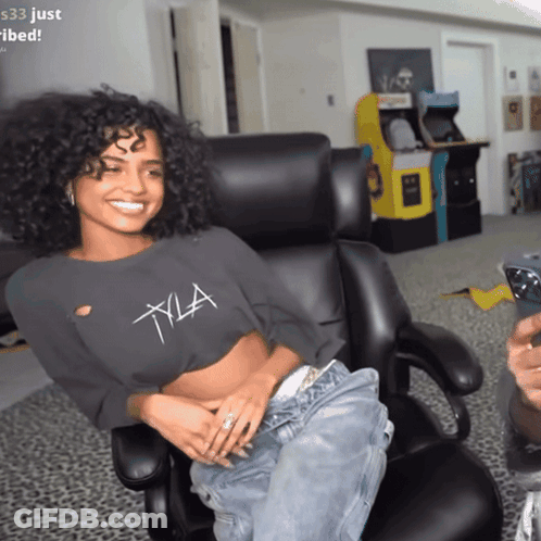 A Woman In A Crop Top With The Letter Xla On It GIF