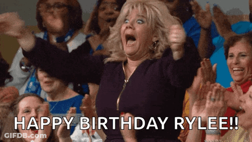 A Woman In A Crowd Says Happy Birthday Rylee In Front Of Her GIF