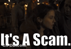 A Woman In A Crowd With The Words It 'S A Scam GIF