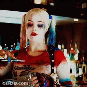 A Woman In A Daddy 'S Monster Costume Pours A Drink Into A Glass GIF