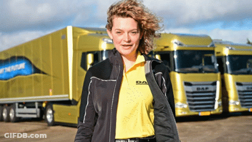 A Woman In A Daf Shirt Stands In Front Of A Truck GIF