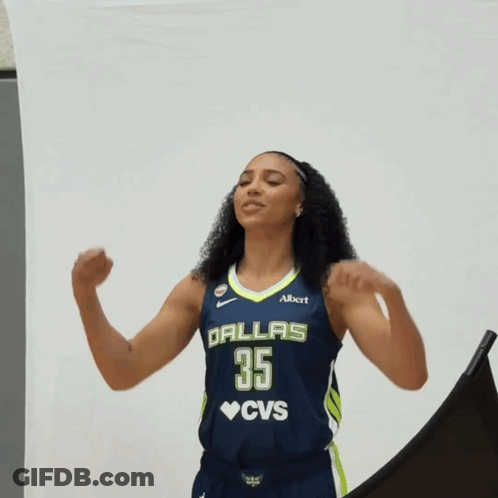 A Woman In A Dallas 35 Cvs Jersey Flexes Her Arms GIF