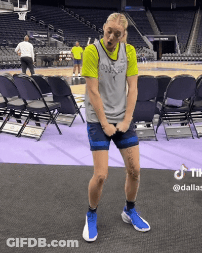 A Woman In A Dallas Jersey Is Standing On A Basketball Court GIF