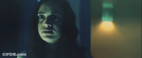 A Woman In A Dark Room With A Light On GIF