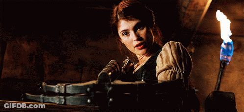A Woman In A Dark Room With A Torch And A Bottle In Her Hand GIF