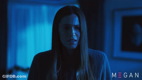 A Woman In A Dark Room With The Name Megan On The Bottom Right GIF