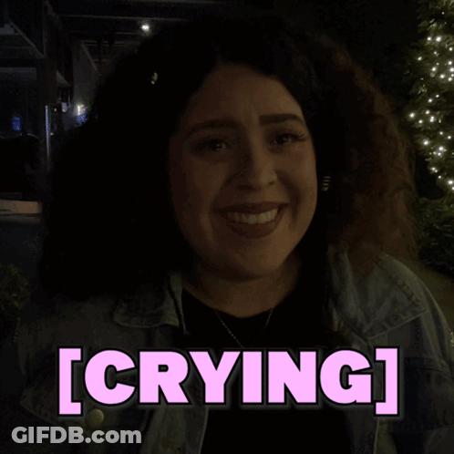 A Woman In A Dark Room With The Word Crying Above Her GIF
