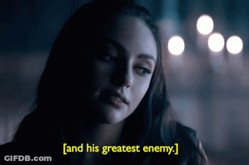 A Woman In A Dark Room With The Words " And His Greatest Enemy " Above Her GIF