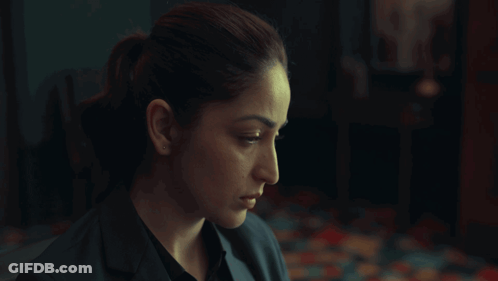 A Woman In A Dark Room With The Words Beware On The Bottom Right GIF
