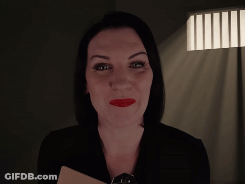 A Woman In A Dark Room With The Words " How Long Have You Been Possessed " Above Her GIF