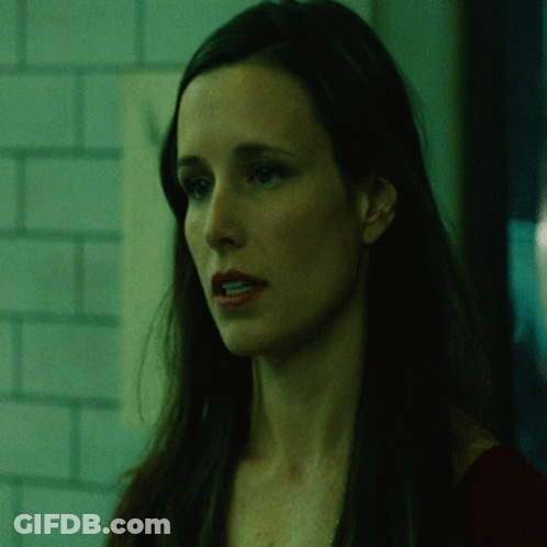 A Woman In A Dark Room With The Words It 'S Begun Behind Her GIF