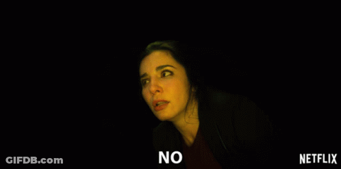 A Woman In A Dark Room With The Words No On The Bottom Right GIF