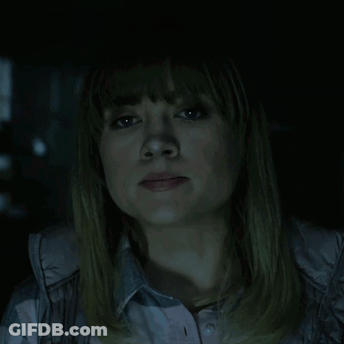 A Woman In A Dark Room With The Words Of Course Written Above Her GIF