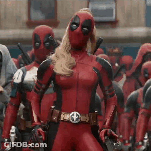 A Woman In A Deadpool Costume Is Standing Next To A Man In A Deadpool Costume . GIF