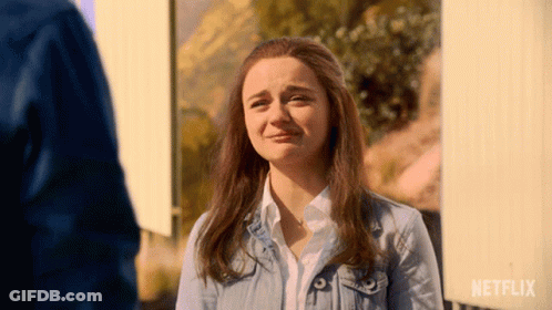 A Woman In A Denim Jacket Is Crying In Front Of A Sign That Says Netflix GIF
