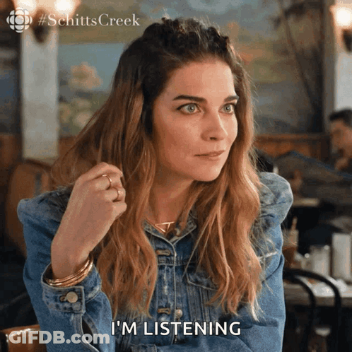Woman In Denim Jacket Saying I'm Listening GIF