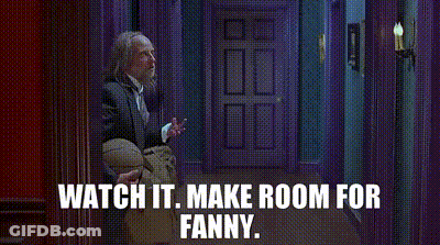 A Woman In A Denim Jacket Is Standing In A Doorway With The Words Watch It Make Room For Fanny Written Above Her . GIF