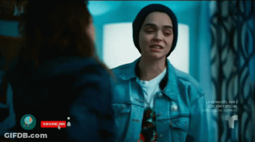 A Woman In A Denim Jacket Is Talking To Another Woman In A Beanie GIF