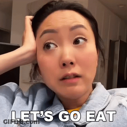 A Woman In A Denim Jacket Says Let 'S Go Eat With Her Hand On Her Head GIF