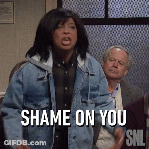 A Woman In A Denim Jacket Says " Shame On You " In Front Of A Group Of People GIF
